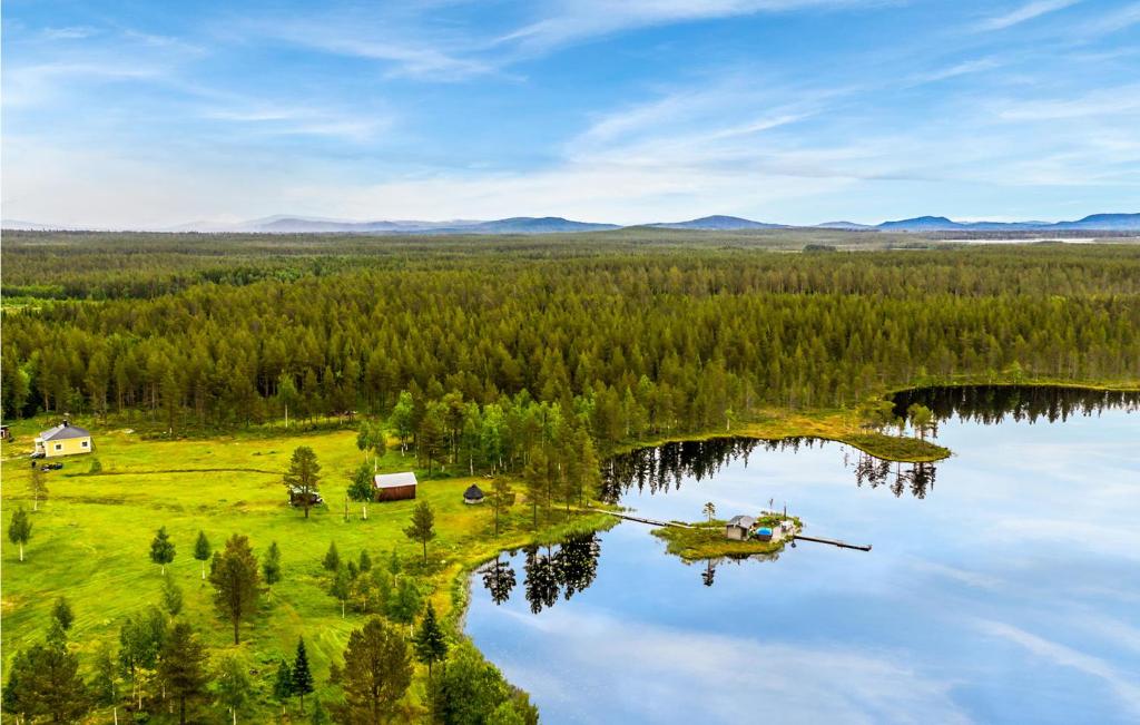 an aerial view of a lake with a house and trees at 2 Bedroom Gorgeous Home In Arvidsjaur in Arvidsjaur