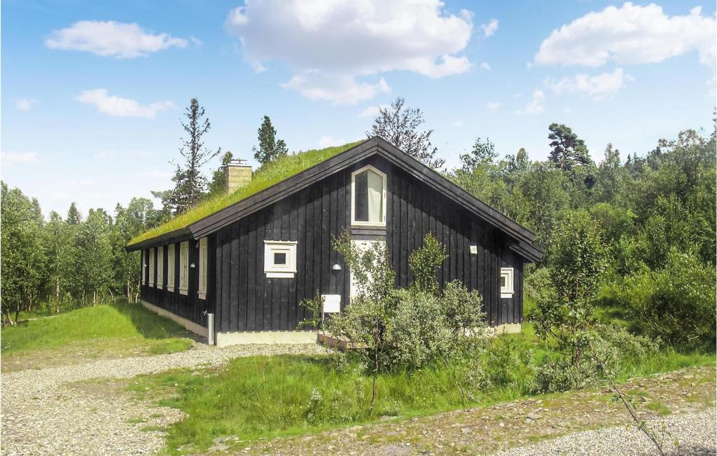 a black house with a grass roof at Beautiful Home In Gl With 3 Bedrooms, Sauna And Wifi in Gålå