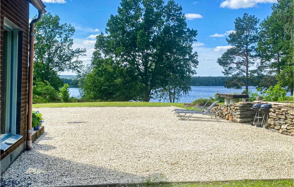 a driveway of a house with a view of the water at Gorgeous Home In Köpmannebro With Wifi in Köpmannebro