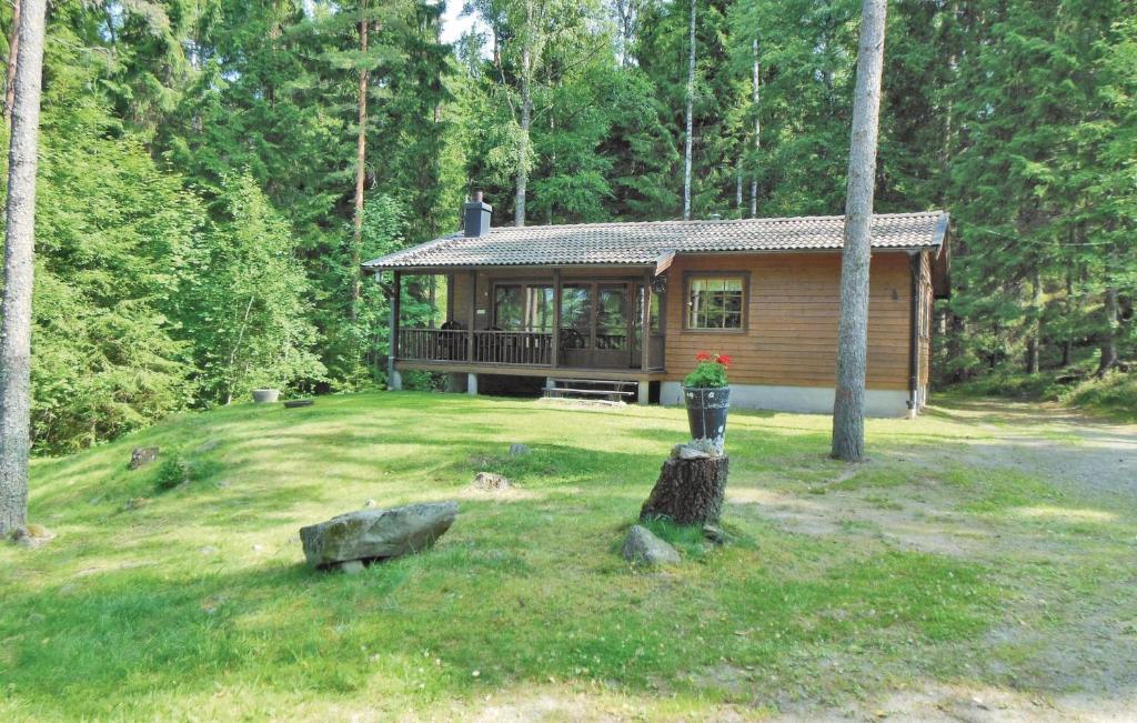 Awesome Home In Gislaved With Lake View في Våthult: كابينة خشب في وسط ساحة