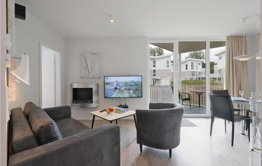 a living room with a couch and a table at Dünenvilla 20, Whg 2 in Travemünde