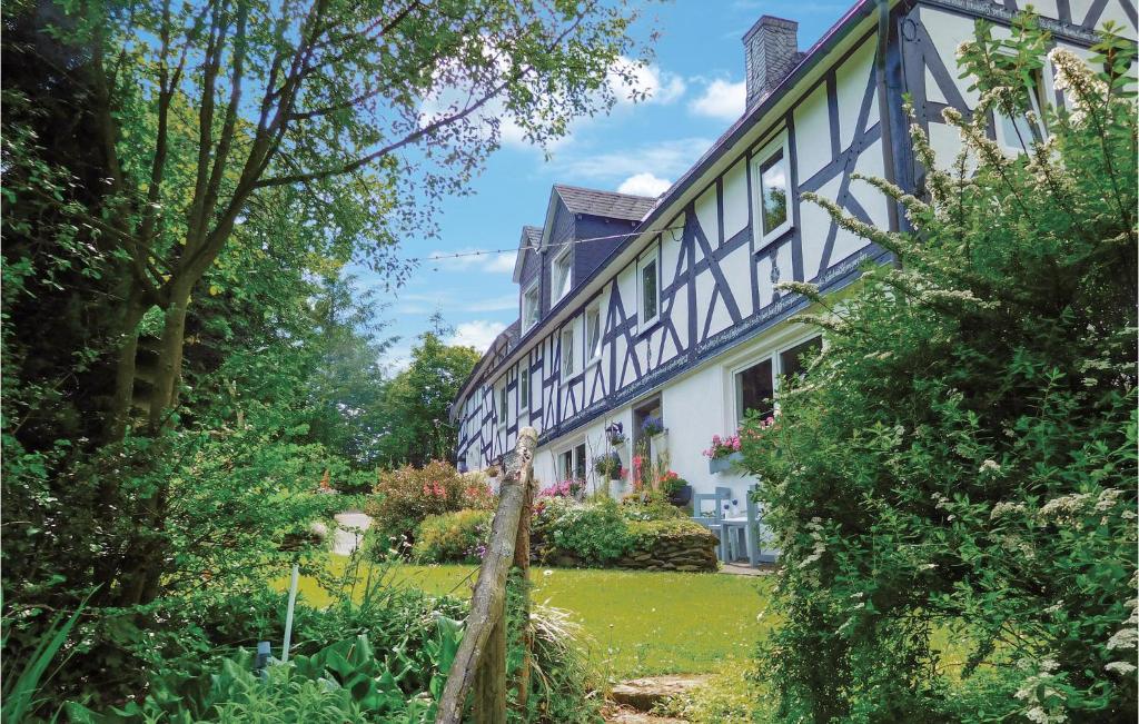 an old house with a garden in front of it at Pet Friendly Apartment In Bad Berleburg-bergh, With Kitchen in Bad Berleburg