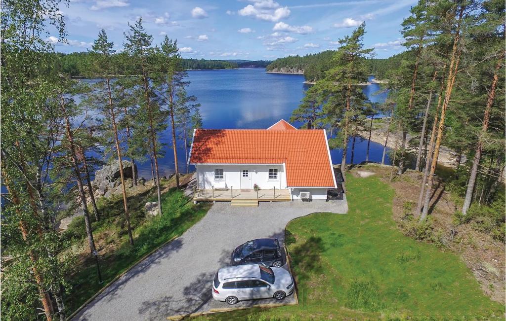 an aerial view of a house with two cars parked at Lovely Home In rjng With House Sea View in Östra Viker