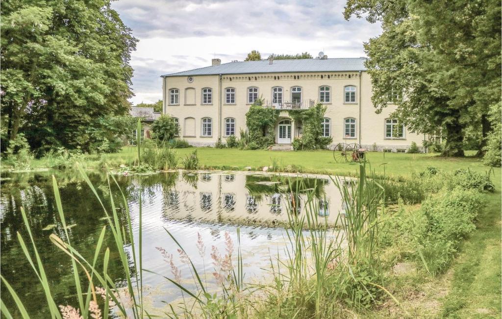 a large house with a pond in front of it at Nice Home In Eichhorst With Kitchen in Friedland