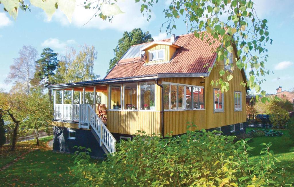 a house with a wrap around porch on the grass at Lovely Home In Spnga With Kitchen in Stockholm