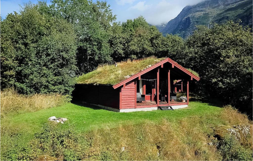 a small house with a grass roof on a field at Flten Hyttegrend in Olden