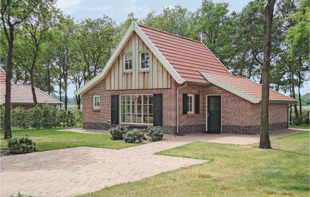 a red brick house with a gambrel roof at Buitengoed Het Lageveld - 55 in Hoge-Hexel