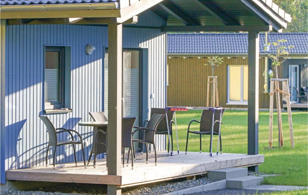 a deck with chairs and a table on a house at Ferienhausdorf Thale in Thale