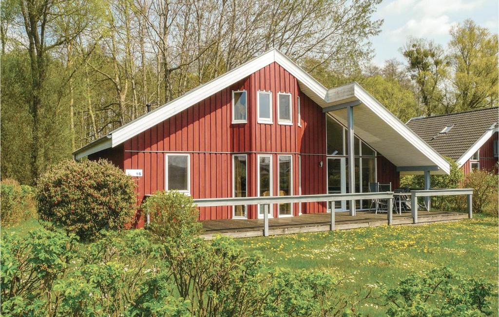 a red house with a white roof at Cozy Home In Rechlin With Wifi in Rechlin