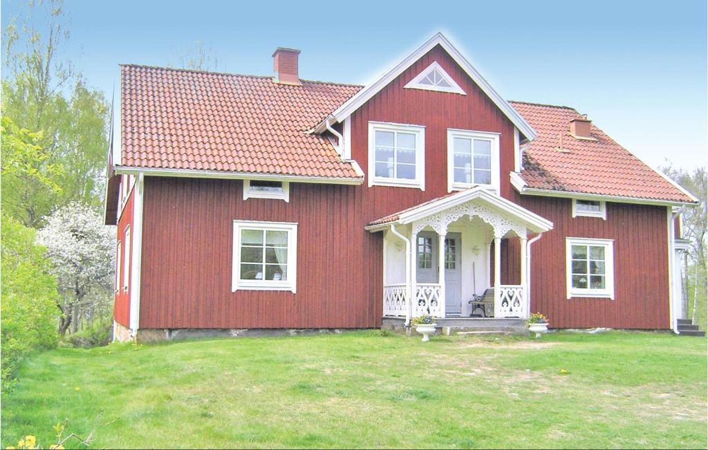 a red house with a red roof at Amazing Home In Agunnaryd With 3 Bedrooms And Wifi in Agunnaryd