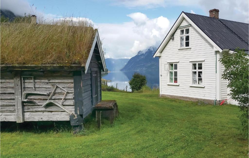 een oud huis en een schuur in een veld bij Naddvik in Naddvik