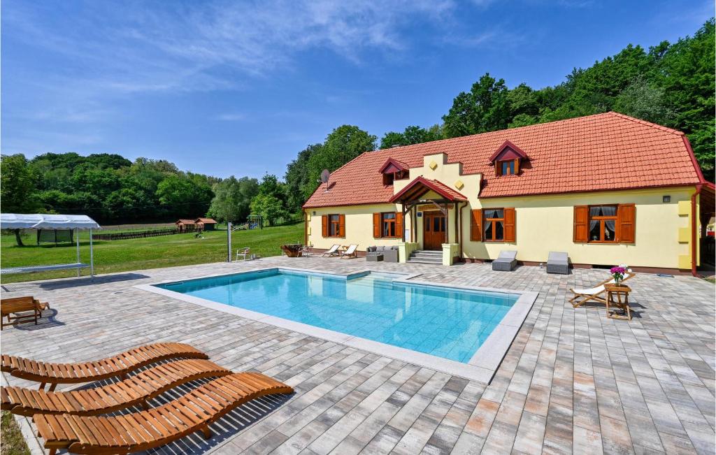 a house with a swimming pool in front of a house at Stunning Home In Konjscina With House A Panoramic View in Husinec
