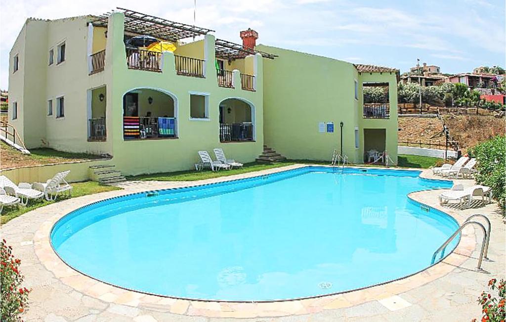 a large swimming pool in front of a house at Villa 4 in Stintino