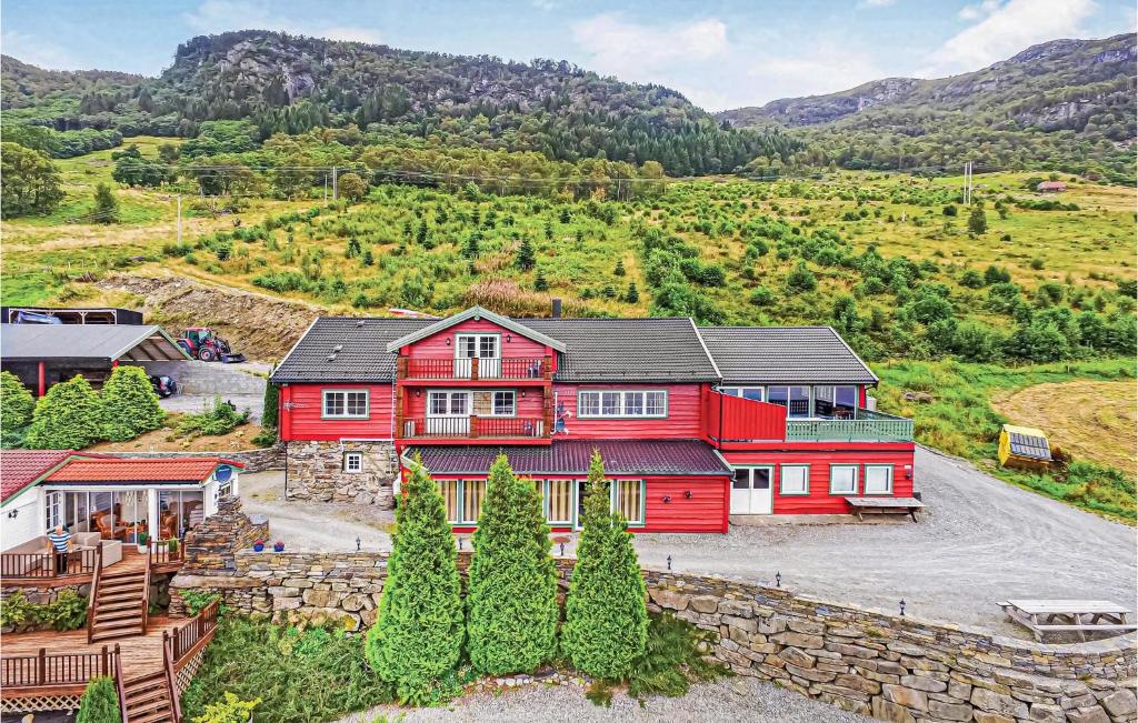 una casa roja en medio de una montaña en 10 Bedroom Amazing Home In Ølen, en Vaka