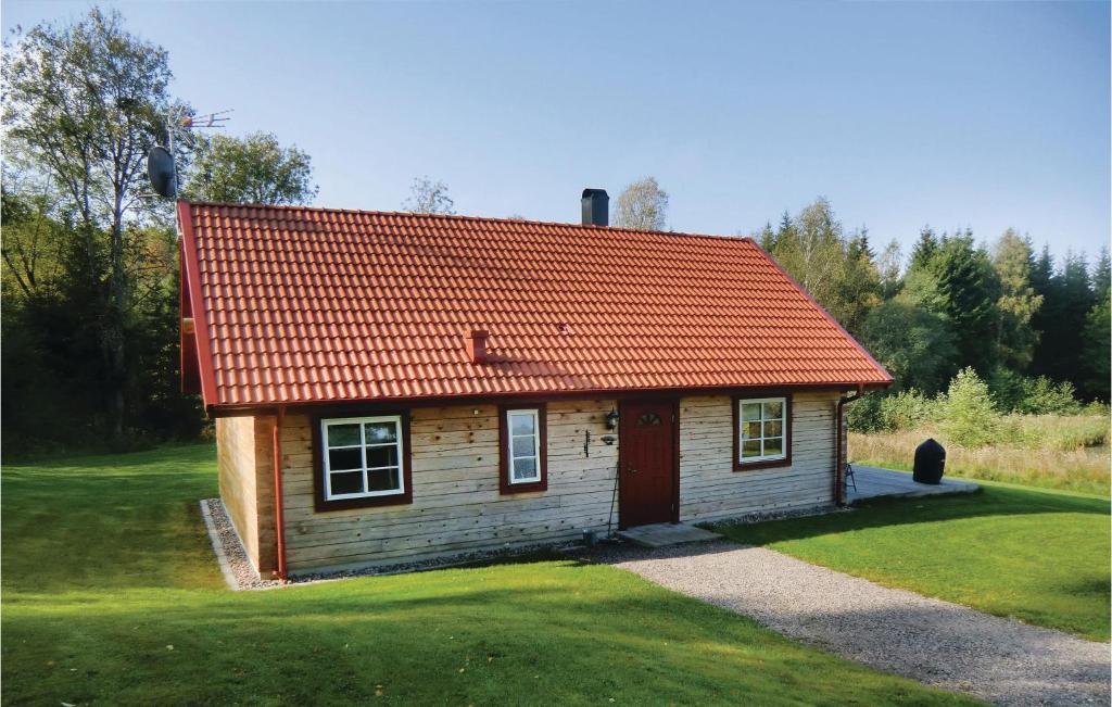 a small wooden house with an orange roof at Stunning Home In Huskvarna With Kitchen in Huskvarna