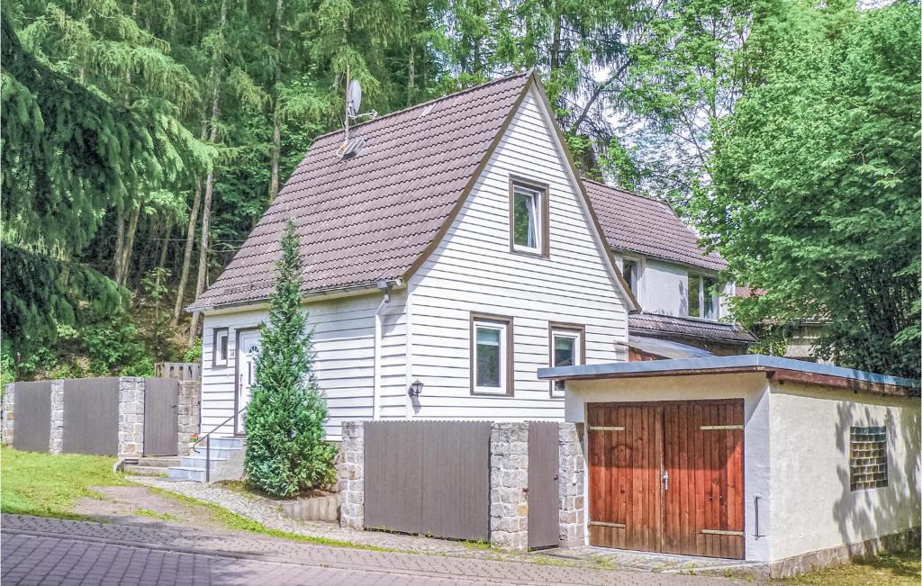 a white house with a gate and a garage at Beautiful Home In Osterode With Kitchen in Osterode