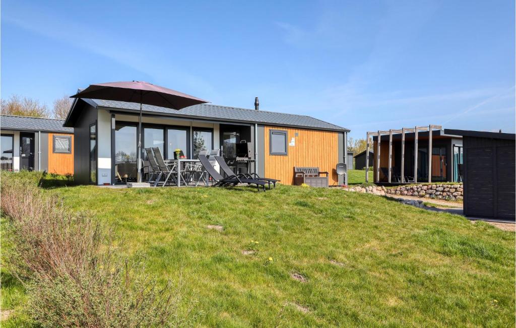 a house with an umbrella on top of a yard at Cozy Home In Ssel With House A Panoramic View in Süsel