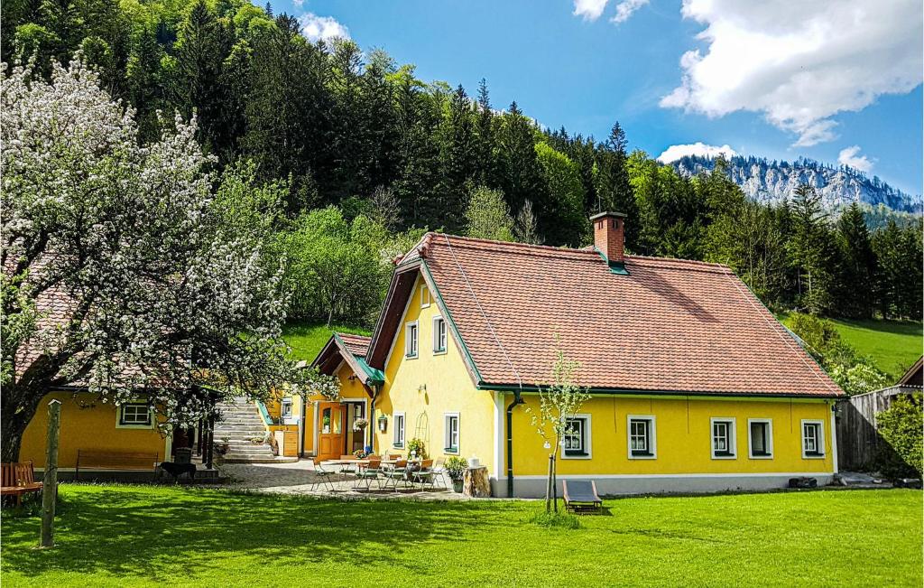 a yellow house in the middle of a field at Stunning Home In Mrzsteg With House A Mountain View in Mürzsteg