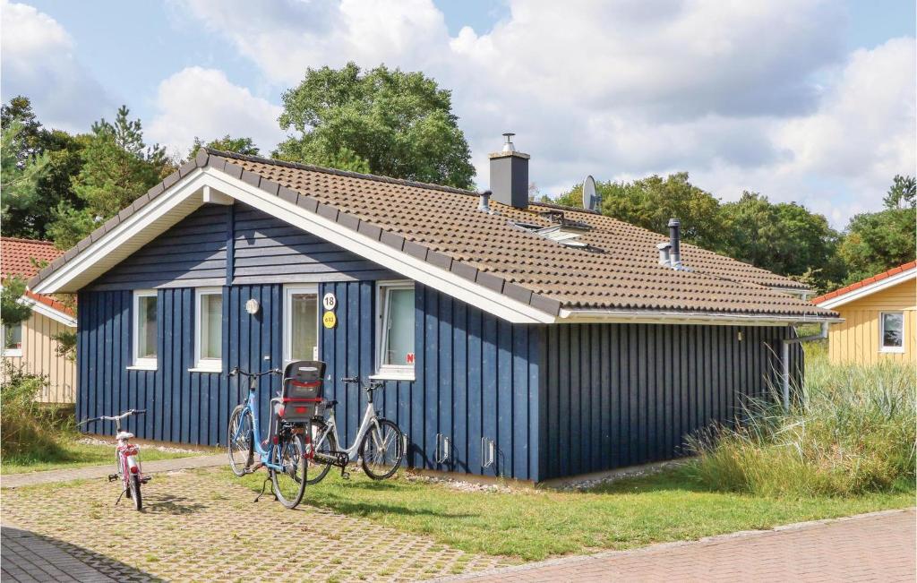 a blue house with a bike parked in front of it at Dnenpark 18 - Dorf 6 in Priwall