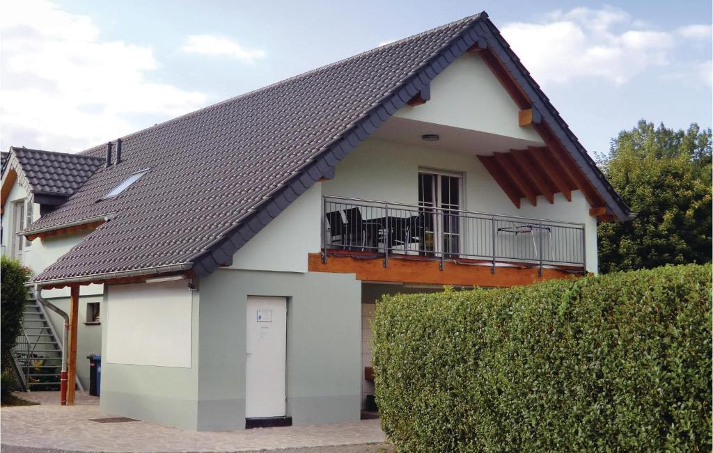 a white house with a black roof at 1 Bedroom Pet Friendly Apartment In Wallendorf-pont in Wallendorf pont