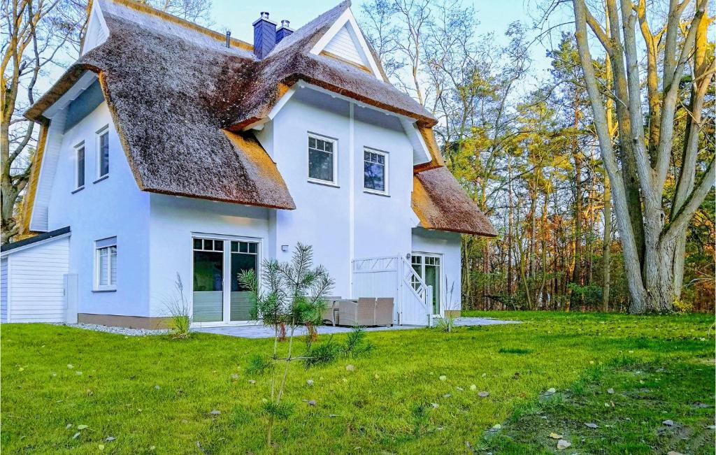 a white house with a rusty roof on a yard at Reetdachhausschilf-Idyll in Kutzow