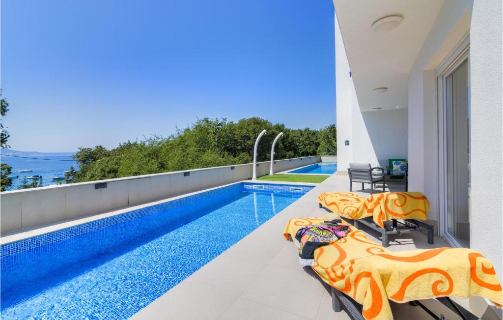 a swimming pool on the roof of a house at Awesome Apartment In Smokvica Krmpotska With Kitchen in Zagreb