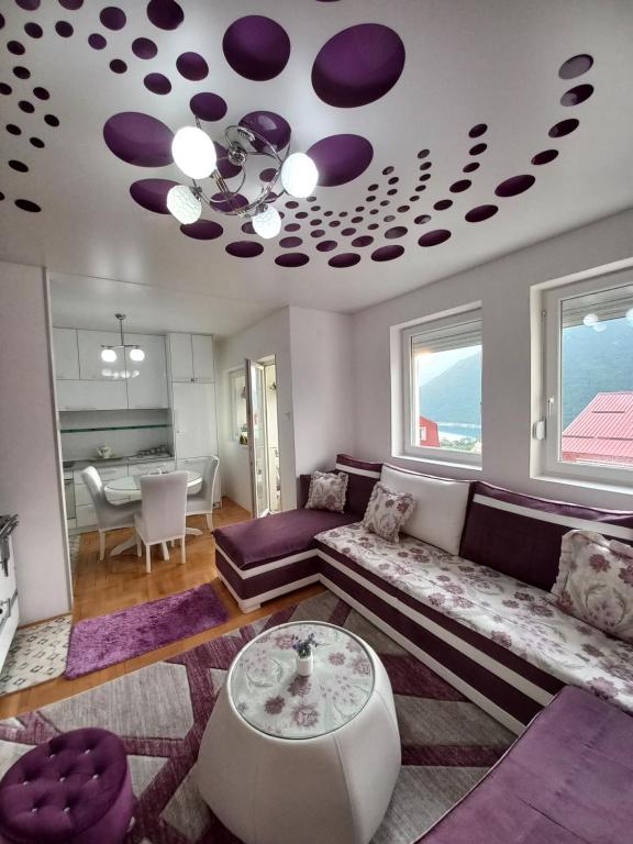 a living room with a couch and a table at APARTMAN PETRA Lux in Plužine