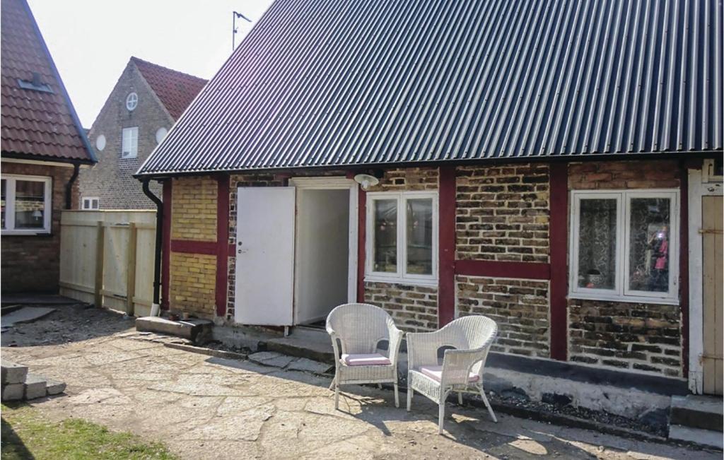 two chairs sitting outside of a brick house at Amazing Apartment In Råå With Kitchen in Råå 