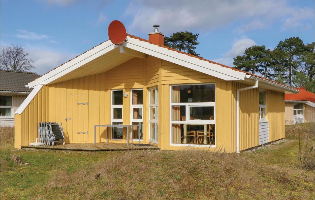ein kleines gelbes Haus mit einem großen Fenster in der Unterkunft Abendrot 2 - Dorf 3 in Priwall