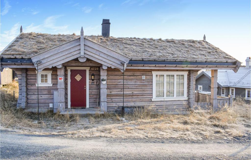 an old wooden house with a red door at Awesome Home In Sjusjen With 3 Bedrooms, Internet And Jacuzzi in Sjusjøen