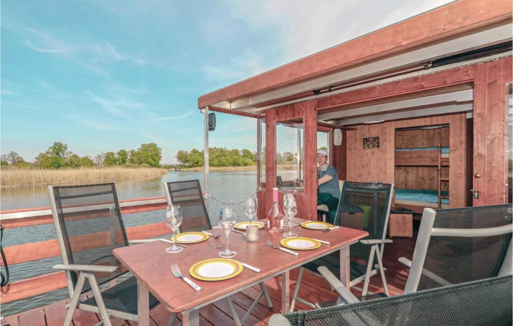 a table on a boat on the water at Awesome Ship In Radewege With Kitchen in Radewege