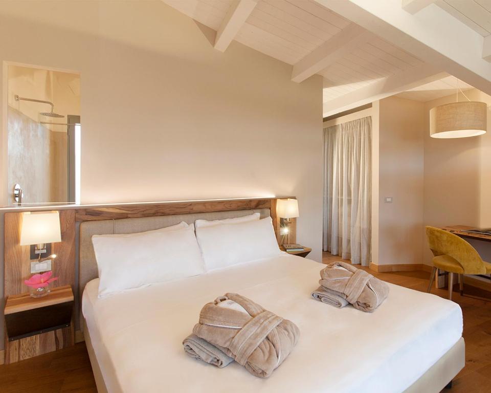 Posteľ alebo postele v izbe v ubytovaní Podere Maremma Spa & Ristorante