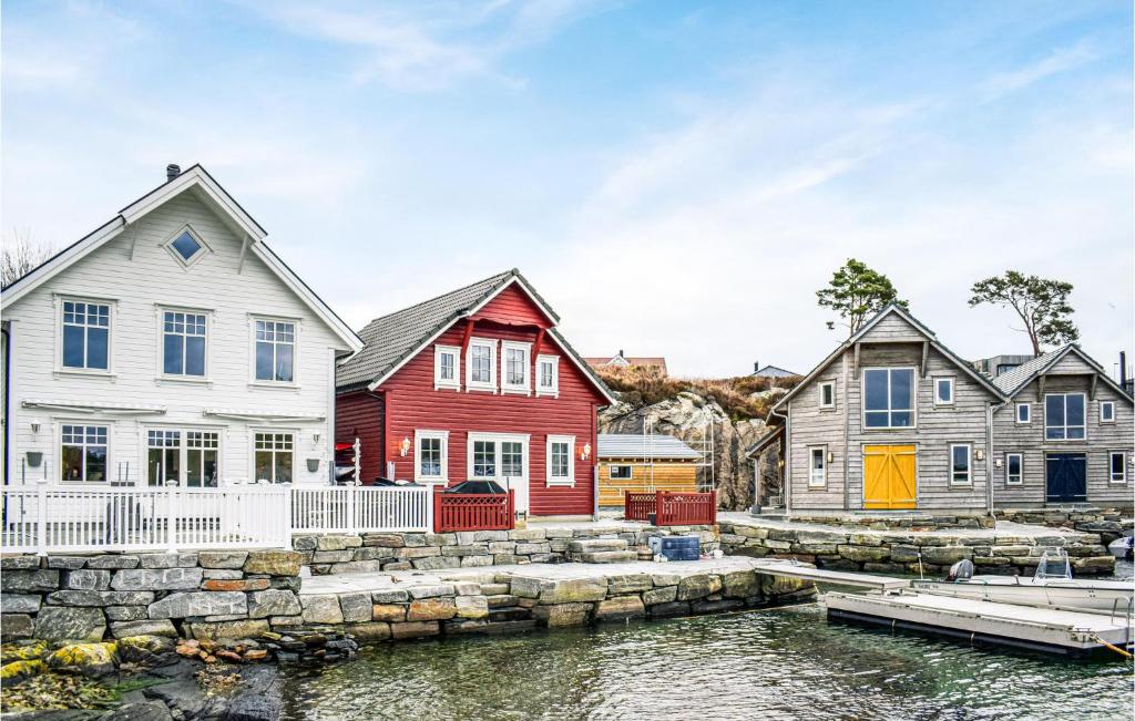 a group of houses next to a body of water at Stunning Home In Mosterhamn With Kitchen in Mosterhamn