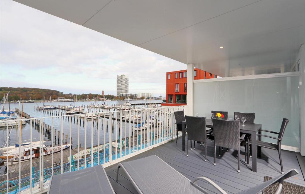 a balcony with a table and chairs and a marina at Promenadenvilla in Priwall