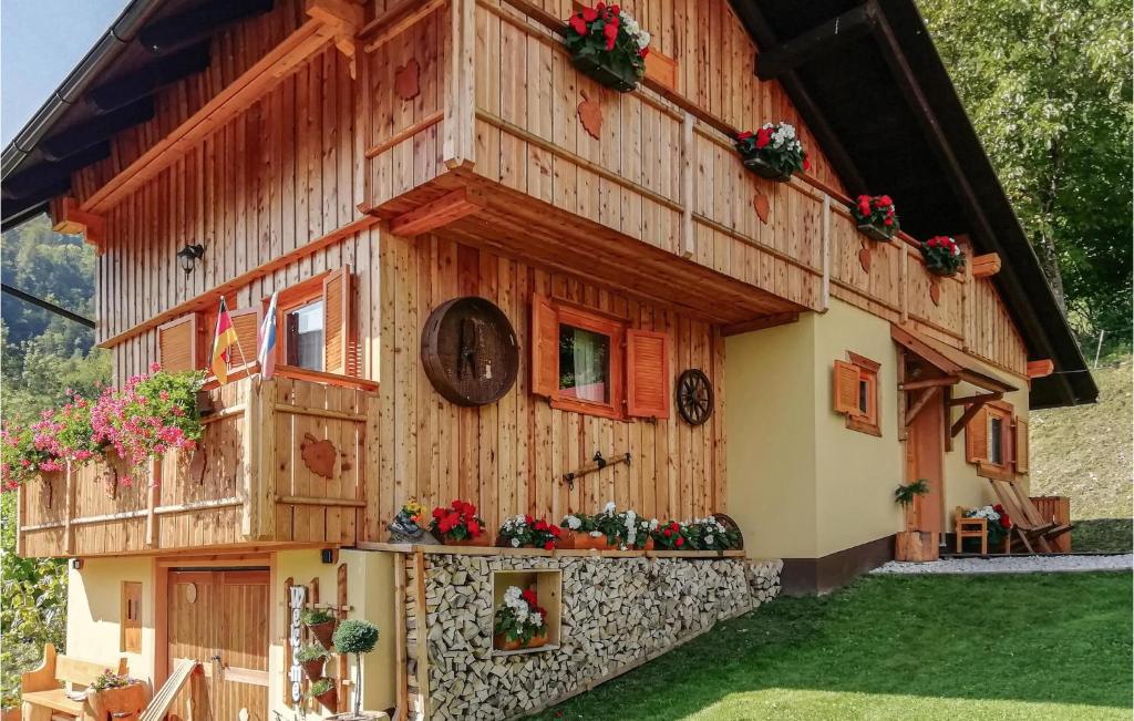 a wooden house with a clock on the side of it at Amazing Home In Luce With 2 Bedrooms And Wifi in Luče