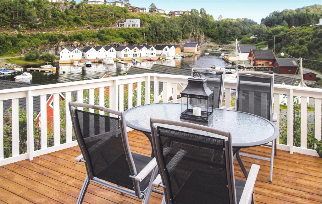 a balcony with a table and chairs and a view of a harbor at Amazing Home In Auklandshamn With House A Mountain View in Vestvik