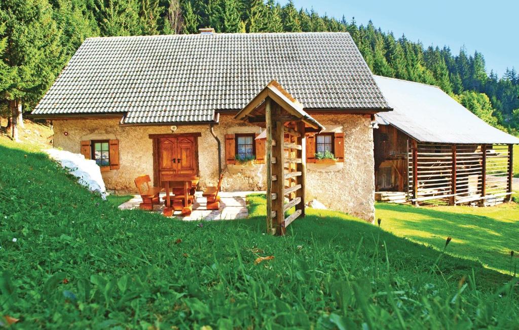 a small house in the middle of a green field at Stunning Apartment In Mozirje With Kitchen in Mozirje