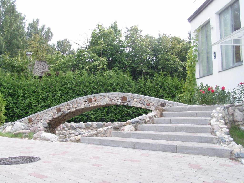 a stone bridge over a set of stairs in front of a building at Kreisā Impērija in Riga