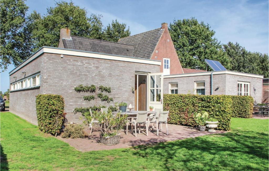 a brick house with a table and chairs in the yard at Beautiful Home In Dongen With 2 Bedrooms And Wifi in Dongen
