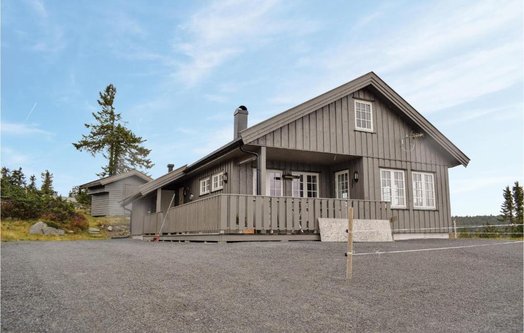 a large house with a driveway at Nice Home In Sjusjen With 3 Bedrooms And Sauna in Sjusjøen