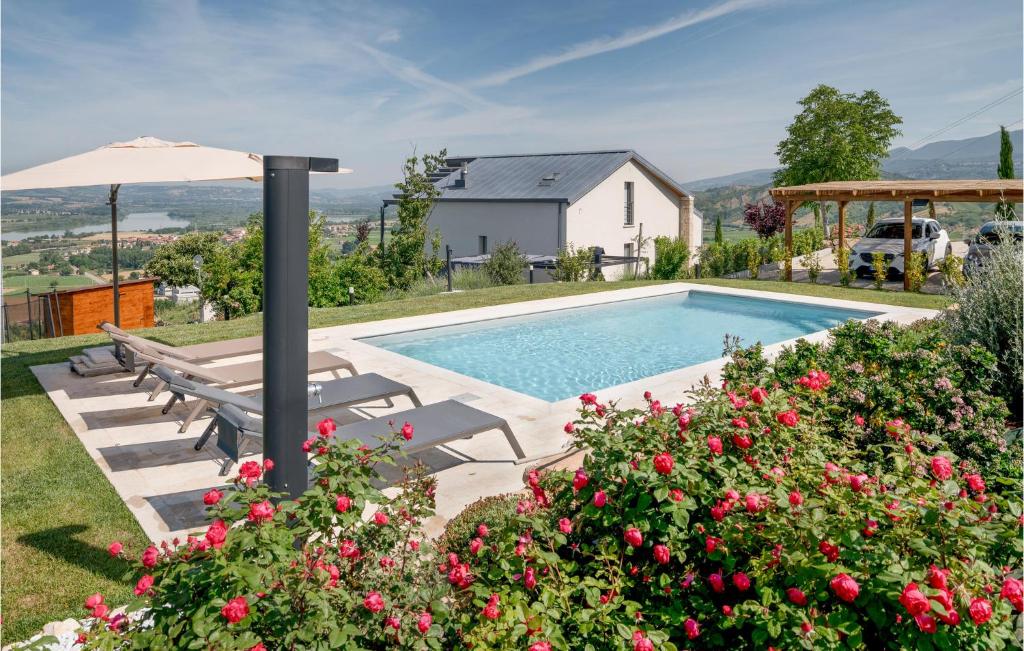 a swimming pool with chairs and an umbrella and some flowers at Lovely Home In Alviano With Kitchen in Alviano