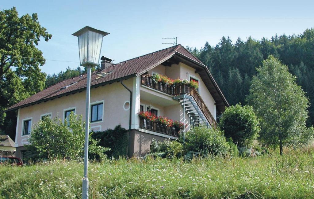 a house with a balcony with flowers on it at 2 Bedroom Nice Apartment In Schnbach in Bärnkopf