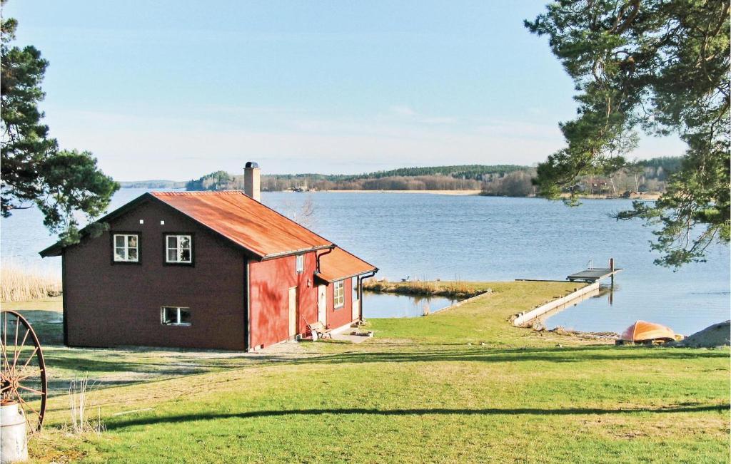a small house on the shore of a lake at Amazing Home In Strngns With 2 Bedrooms And Sauna in Aspö