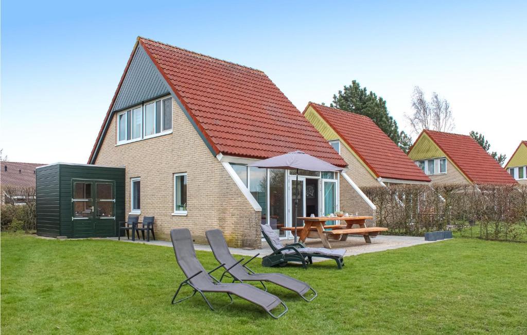 una casa con 2 sillas y una mesa en el patio en Awesome Home In Vlagtwedde With House Sea View, en Vlagtwedde
