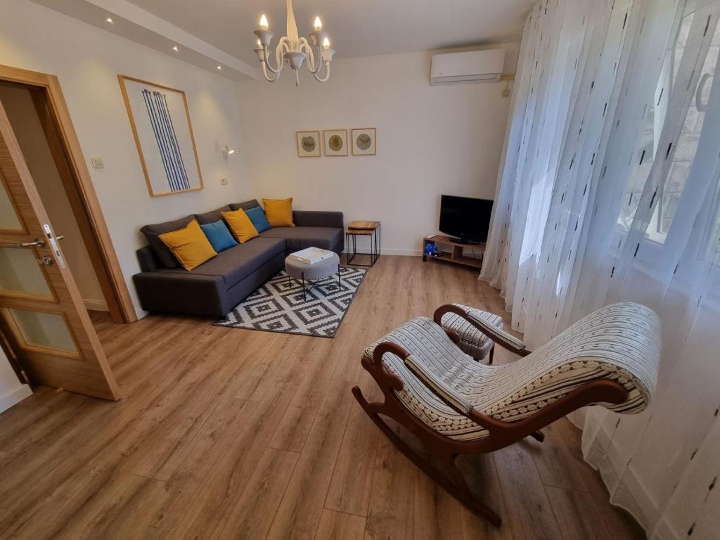 a living room with a couch and a chair at Golden Fields Apartment near the Old Town in Kotor