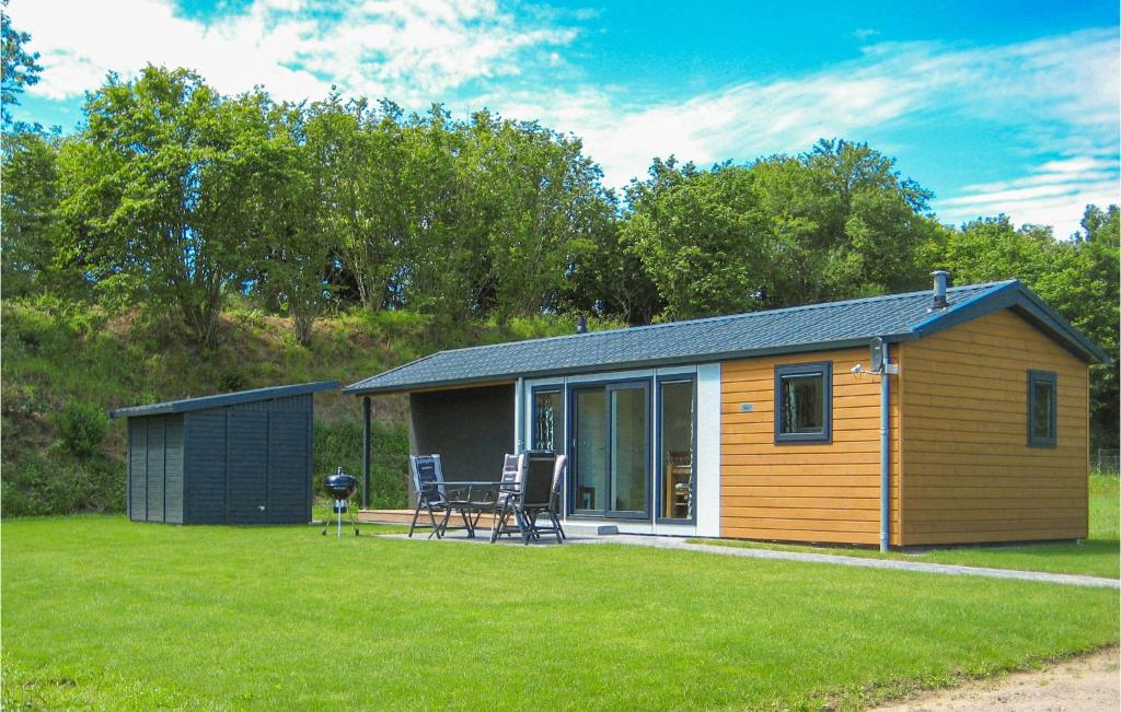 a small shed with a table and chairs in a yard at Nice Home In Ssel With Kitchen in Süsel