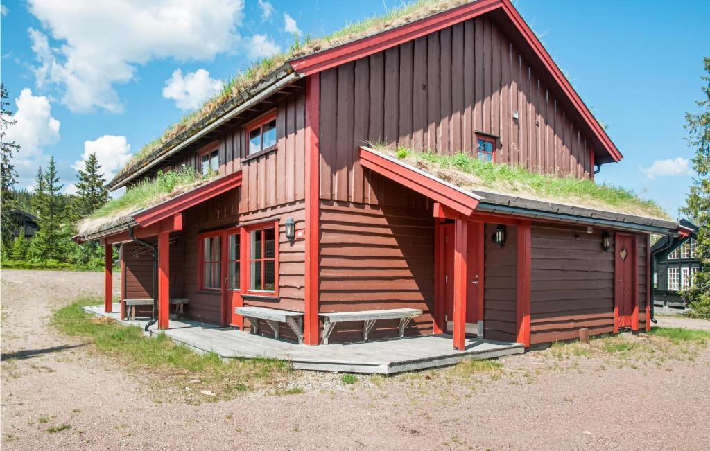 a log cabin with grass on the roof at Cozy Home In Trysil With Ethernet Internet in Mælem