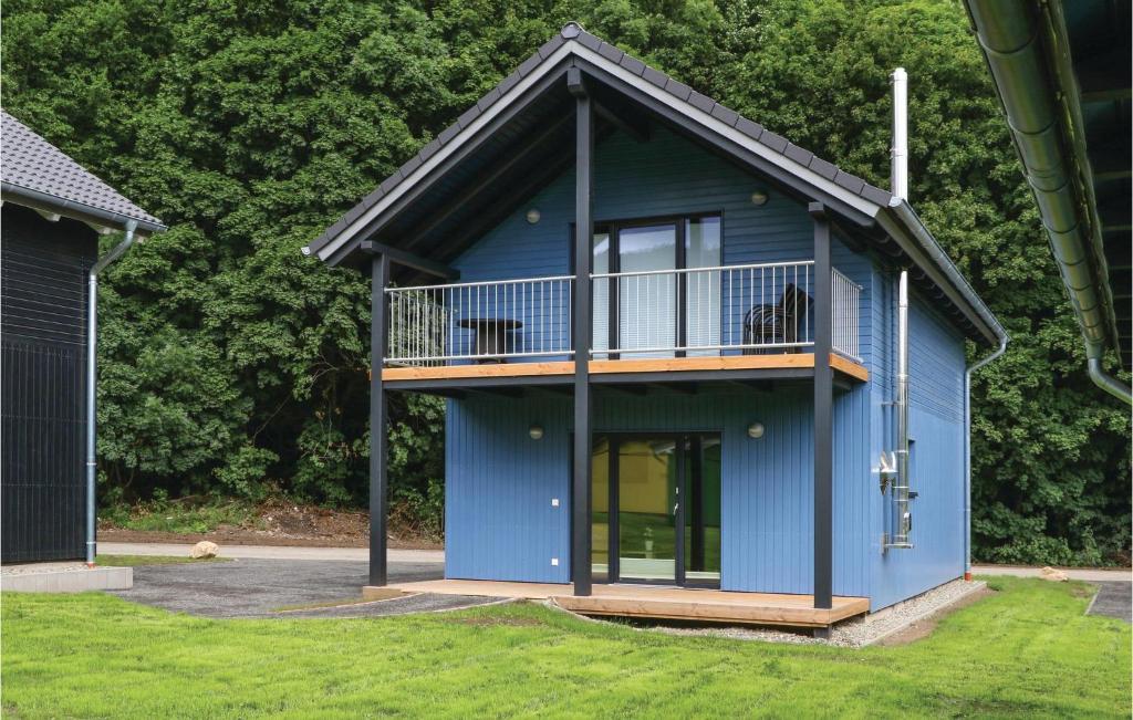 ein blaues Haus mit Balkon darüber in der Unterkunft Ferienhausdorf Thale in Thale
