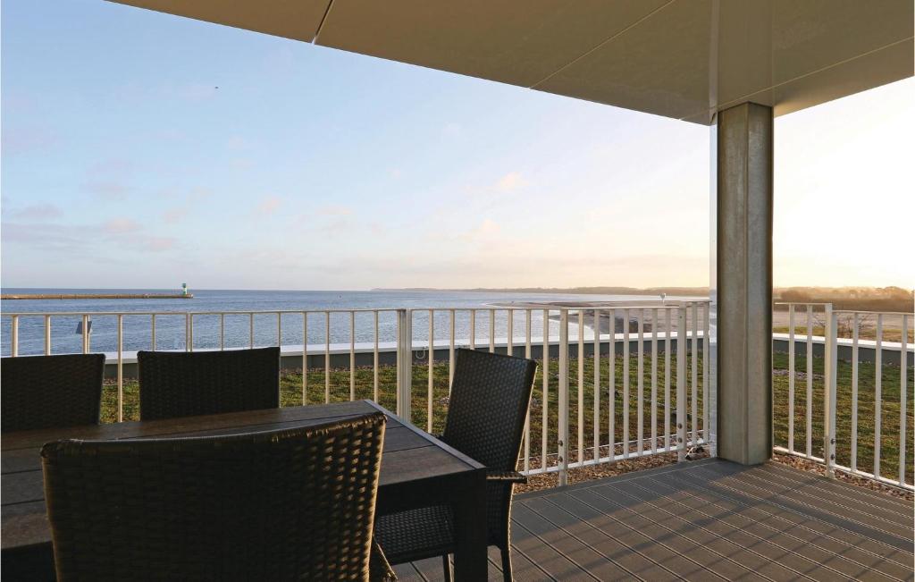 a balcony with a table and chairs and the ocean at Priwallpromenade 1, Whg 3 in Travemünde