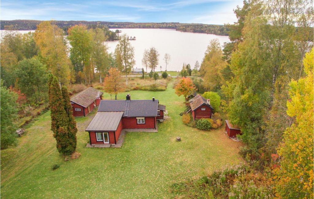 an aerial view of a house on a field with a lake at 3 Bedroom Awesome Home In Grythyttan in Grythyttan